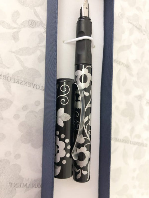 Cufflinks and a black fountain pen with a silver ornament